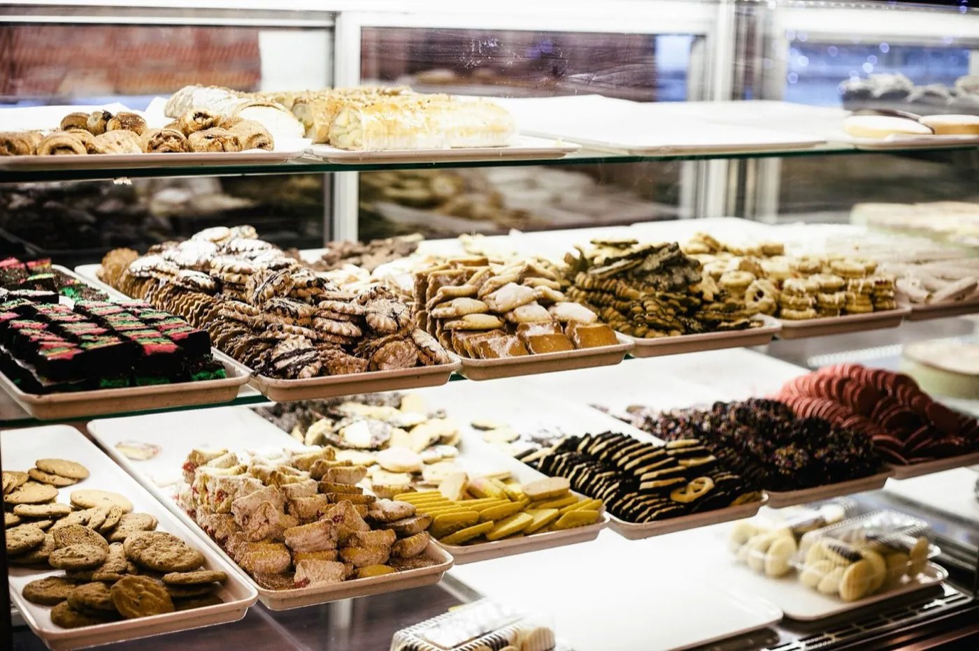 A bakery display case full of cookies and pastries